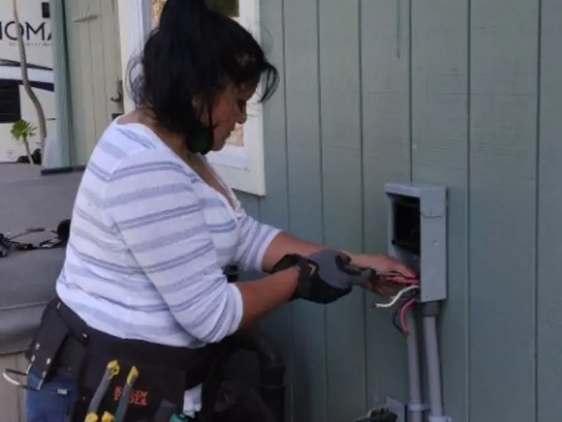 Licensed electrician wiring an exterior subpanel in Fresno